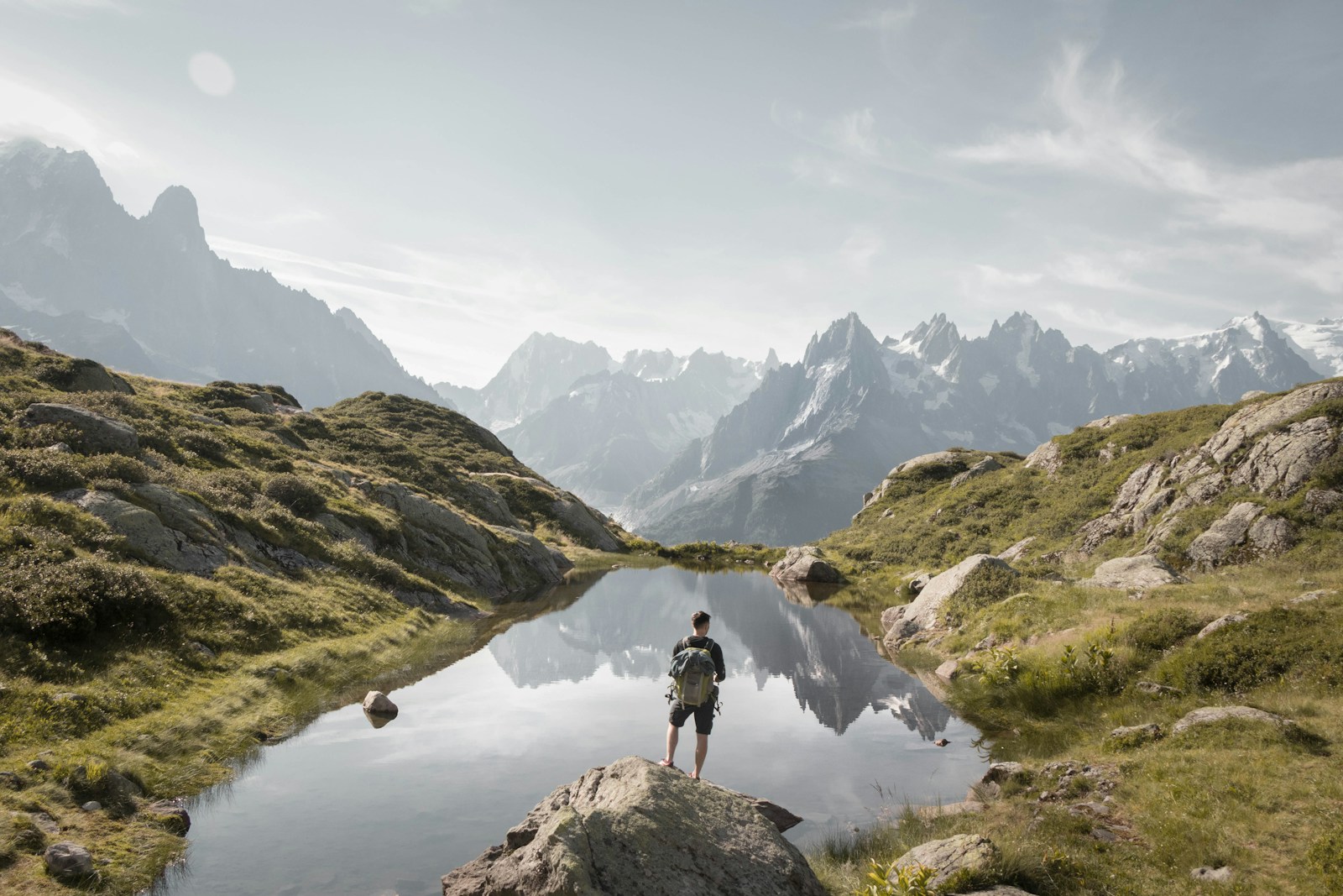 person standing on rock mountain during daytime